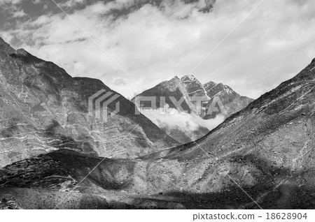 mountain peaks through the clouds 18628904