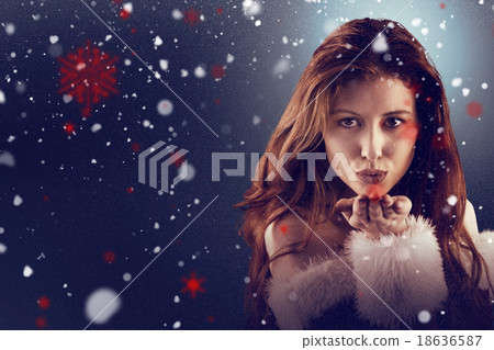 Composite image of festive redhead blowing a kiss 18636587