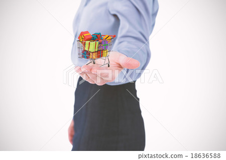 Composite image of businesswoman presenting with hand 18636588