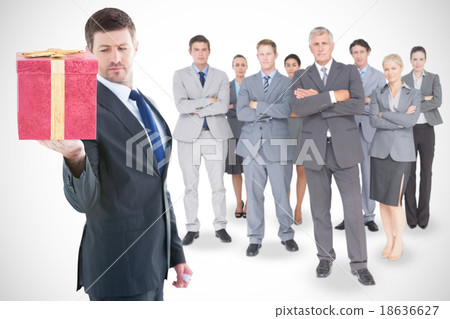 Composite image of businessman holding hand out in presentation Composite image of businessman holding hand out in presentation 18636627