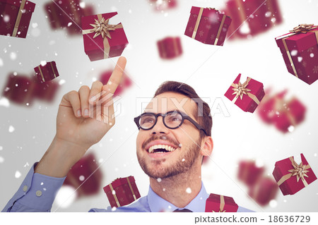 Composite image of happy businessman with glasses pointing 18636729