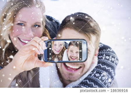 Composite image of hand holding smartphone showing Composite image of hand holding smartphone showing 18636916