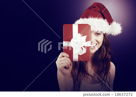 Festive redhead holding a gift Festive redhead holding a gift 18637272