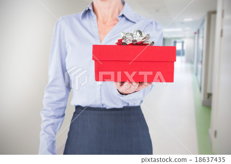 Composite image of businesswoman holding digital tablet 18637435