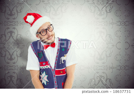 Composite image of geeky hipster in santa hat 18637731