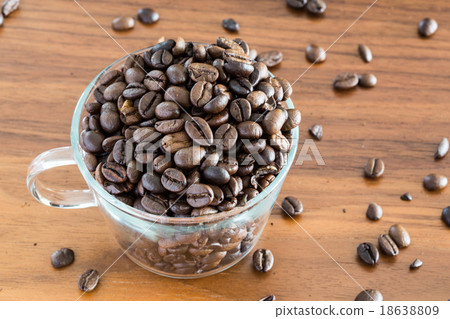 Coffee bean in a transparent cup on a wooden table 18638809