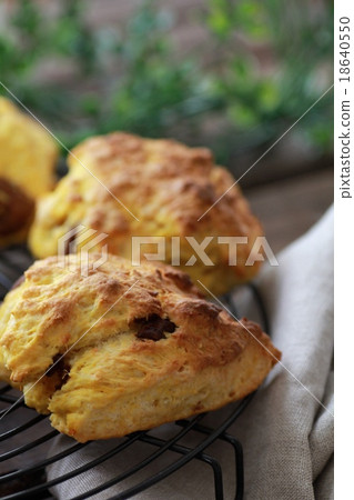 Pumpkin chocolate chunk scones on a cake cooler 18640550