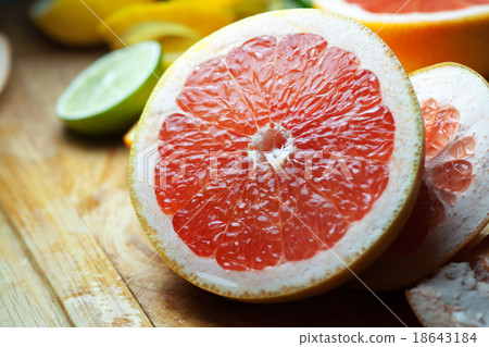 Grapefruit with slices on a wooden table 18643184