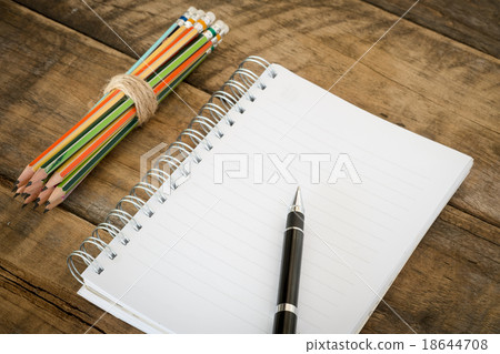 Notebook, pencil and pen on wooden table Notebook, pencil and pen on wooden table 18644708