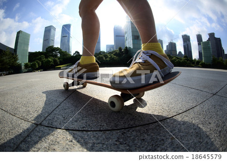 skateboarder skateboarding at sunrise city 18645579