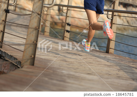 fitness sports woman running on wooden boardwalk  18645781