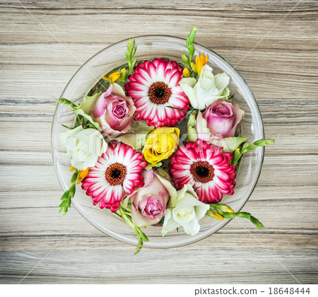 Arangement with roses and gerberas flowers in the glass bowl wit Arangement with roses and gerberas flowers in the glass bowl wit 18648444