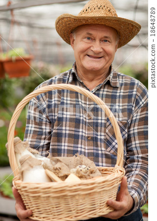 Skillful farm worker is carrying dairy products Skillful farm worker is carrying dairy products 18648789