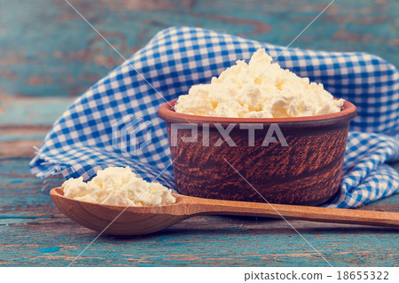 Fresh cottage cheese in a ceramic dish and spoon Fresh cottage cheese in a ceramic dish and spoon 18655322