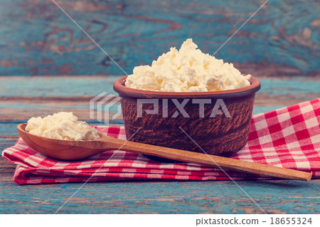 Fresh cottage cheese in a ceramic dish and spoon 18655324