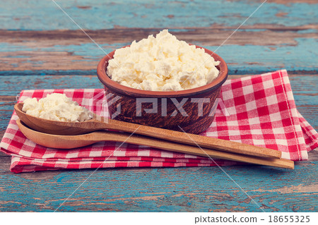 Fresh cottage cheese in a ceramic dish and spoon 18655325