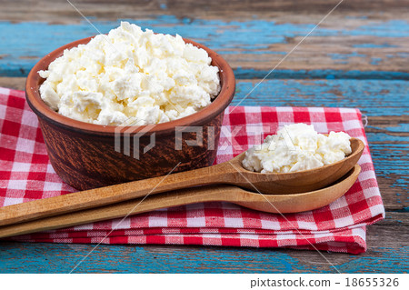 Fresh cottage cheese in a ceramic dish and spoon 18655326