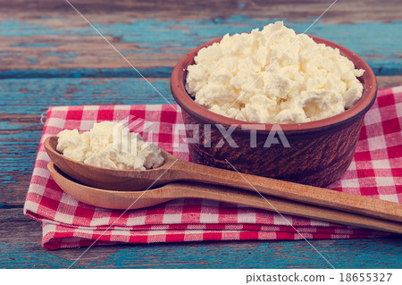 Fresh cottage cheese in a ceramic dish and spoon 18655327