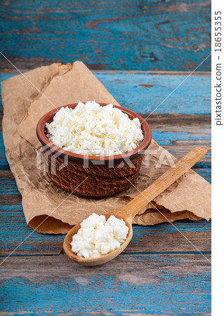 Fresh cottage cheese in a ceramic dish and spoon Fresh cottage cheese in a ceramic dish and spoon 18655355