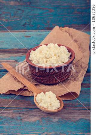 Fresh cottage cheese in a ceramic dish and spoon Fresh cottage cheese in a ceramic dish and spoon 18655356