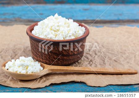Fresh cottage cheese in a ceramic dish and spoon Fresh cottage cheese in a ceramic dish and spoon 18655357