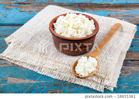 Fresh cottage cheese in a ceramic dish and spoon Fresh cottage cheese in a ceramic dish and spoon 18655361
