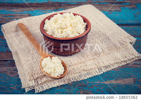 Fresh cottage cheese in a ceramic dish and spoon Fresh cottage cheese in a ceramic dish and spoon 18655362