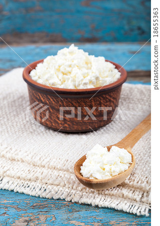 Fresh cottage cheese in a ceramic dish and spoon Fresh cottage cheese in a ceramic dish and spoon 18655363