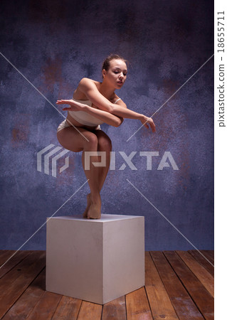 Young beautiful dancer in beige swimwear posing on 18655711