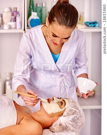 Stock Photo: Woman middle-aged take face massage in spa salon.