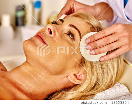 Stock Photo: Woman middle-aged take face cleaning in spa salon.