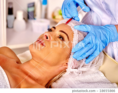 Woman middle-aged in spa salon with beautician 18655866