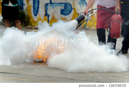fire extinguisher on a training fire fire extinguisher on a training fire 18659639