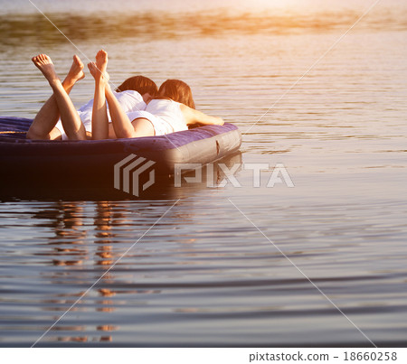 Young couple on the swimming mattress Young couple on the swimming mattress 18660258