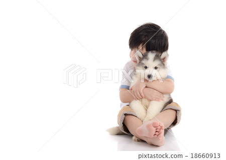 Cute asian boy sitting with siberian husky puppy Cute asian boy sitting with siberian husky puppy 18660913