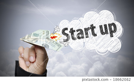 hand holding dollar plane with start up text hand holding dollar plane with start up text 18662082