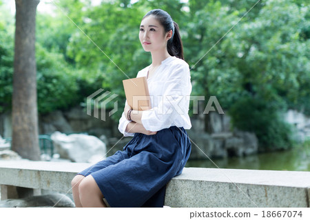 girl reading in the park girl reading in the park 18667074