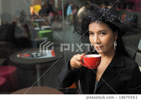 Asian woman with cup of coffee 18670561