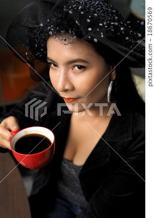 Asian woman with cup of coffee 18670569