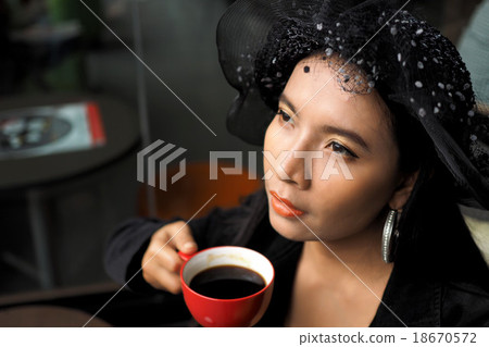 Asian woman with cup of coffee 18670572