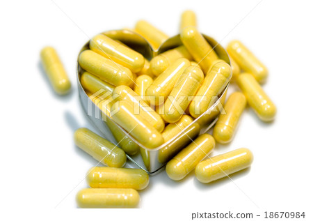 yellow capsule heart isolated on white background yellow capsule heart isolated on white background 18670984