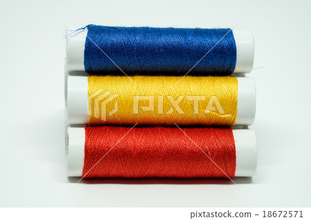 Three spools of threads, blue, yellow, red 18672571