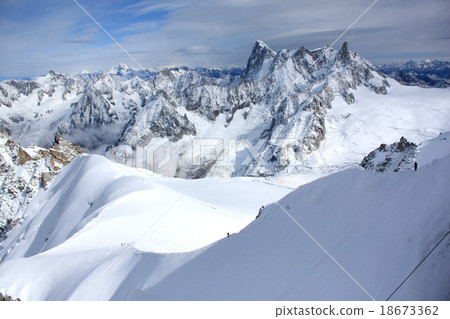 A climber aiming to climb Mont Blanc as seen from the Aiguille du Midi observatory stand in France A climber aiming to climb Mont Blanc as seen from the Aiguille du Midi observatory stand in France 18673362