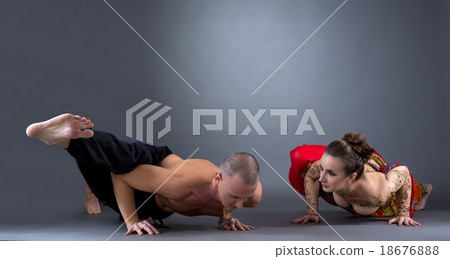 Yoga. Beautiful couple doing difficult asana Yoga. Beautiful couple doing difficult asana 18676888