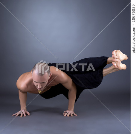 Studio photo of middle-aged man practicing yoga Studio photo of middle-aged man practicing yoga 18676889
