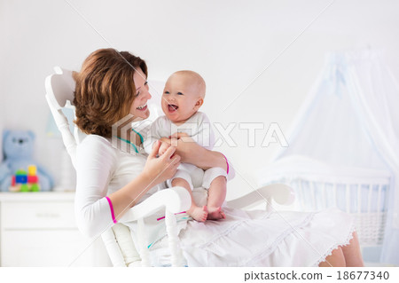 Stock Photo: Mother and baby in white bedroom