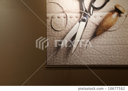 Scissors, leather and thread in photo frame 18677582
