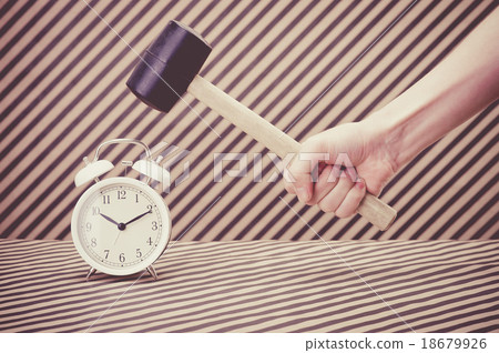 Hand that breaks the alarm clock with a hammer 18679926