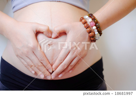 pregnant woman made her hand heart symbol 18681997