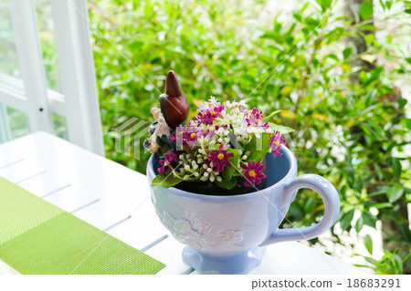 fake purple flower in blue ceramic cup fake purple flower in blue ceramic cup 18683291